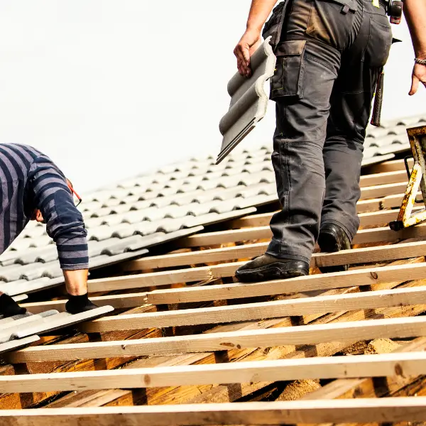Roofers working on a tiled roof